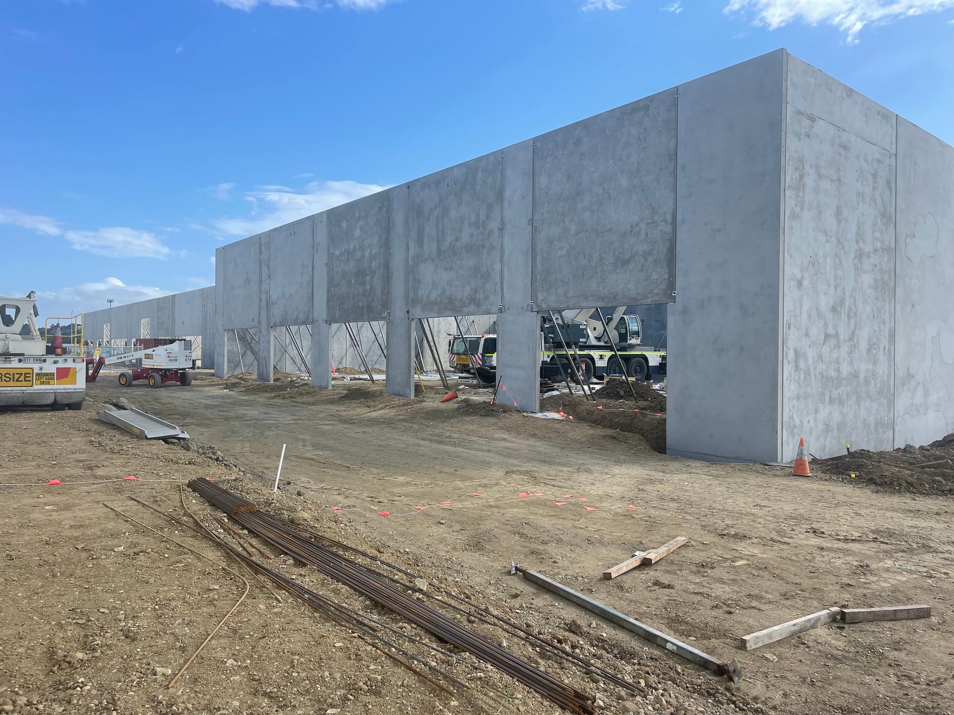 A Large Concrete Building Is Being Built In A Dirt Field — Mass Construction Group Australia Pty Ltd in South Mackay, QLD