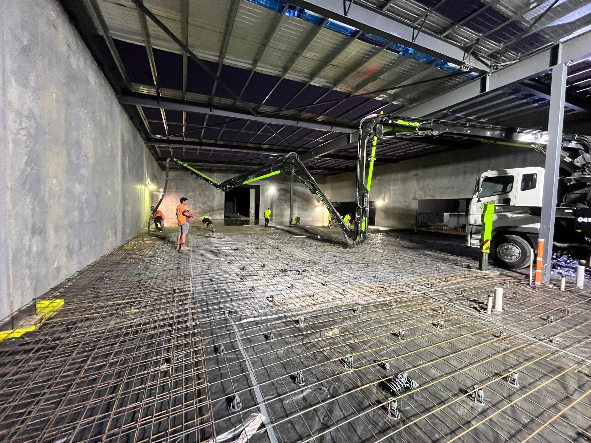 A Truck Is Pumping Concrete Into A Building Under Construction — Mass Construction Group Australia Pty Ltd in South Mackay, QLD