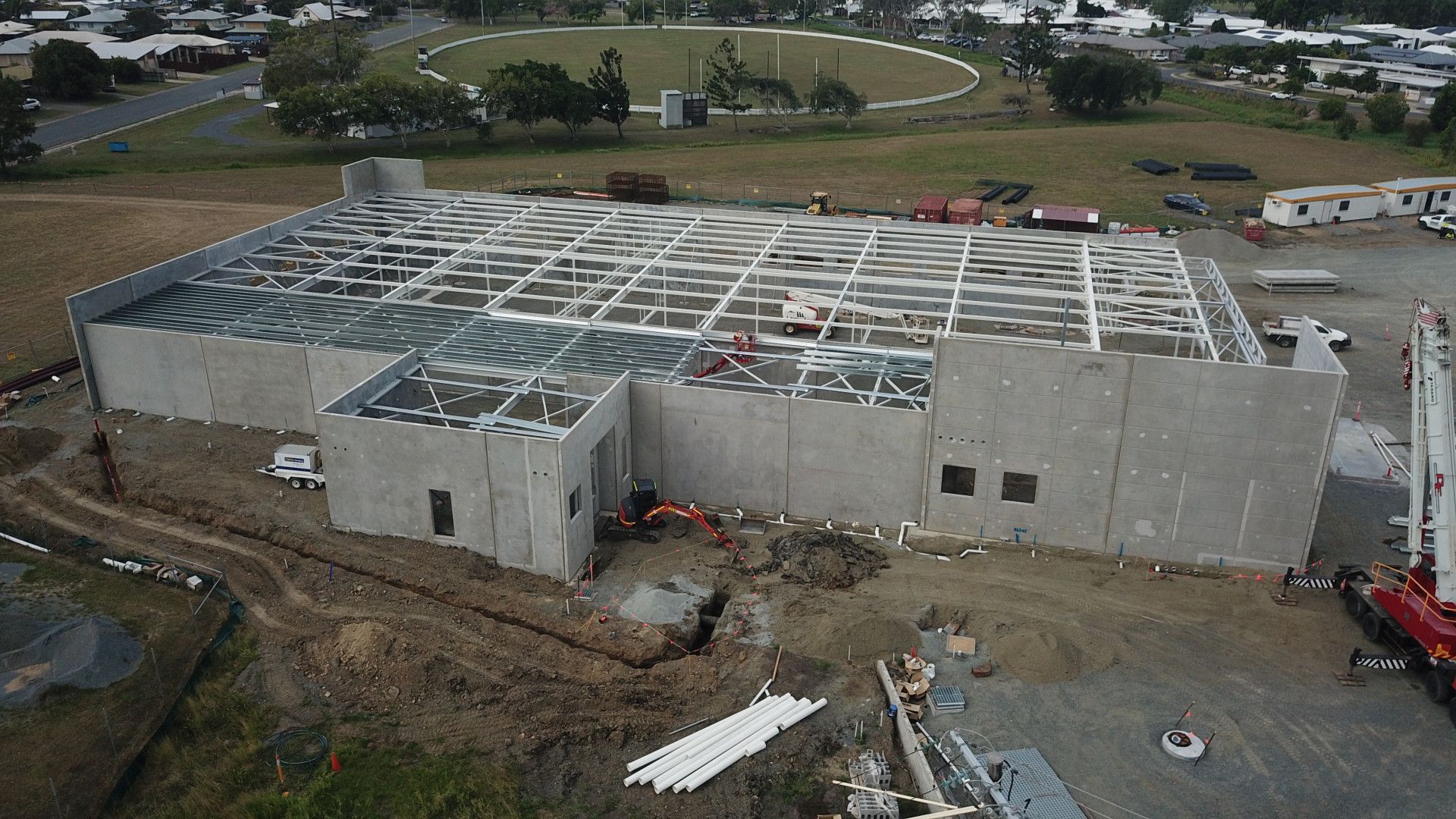 A Yellow Excavator Is Digging a Hole Lake Side — Mass Construction Group Australia Pty Ltd in South Mackay, QLD