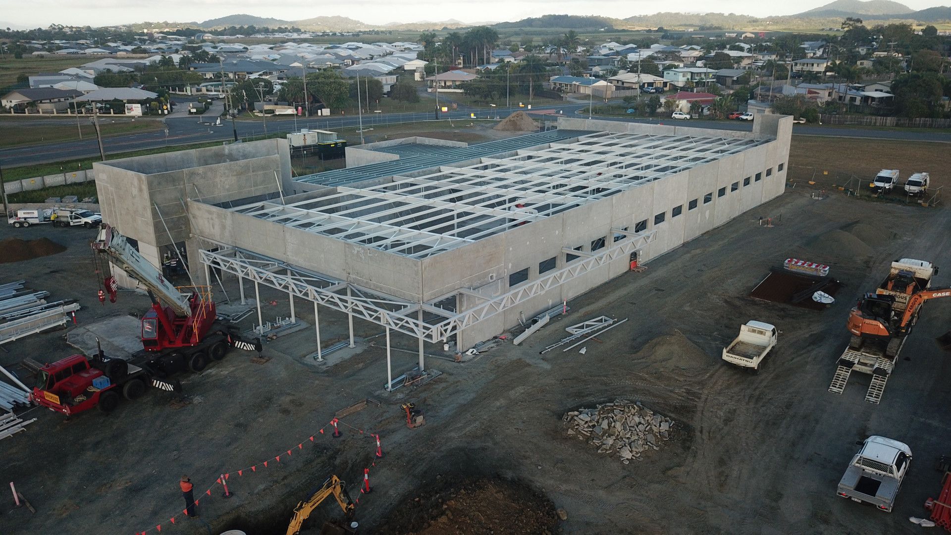 A Yellow Excavator Is Digging a Pile of Dirt in A Field — Mass Construction Group Australia Pty Ltd in South Mackay, QLD
