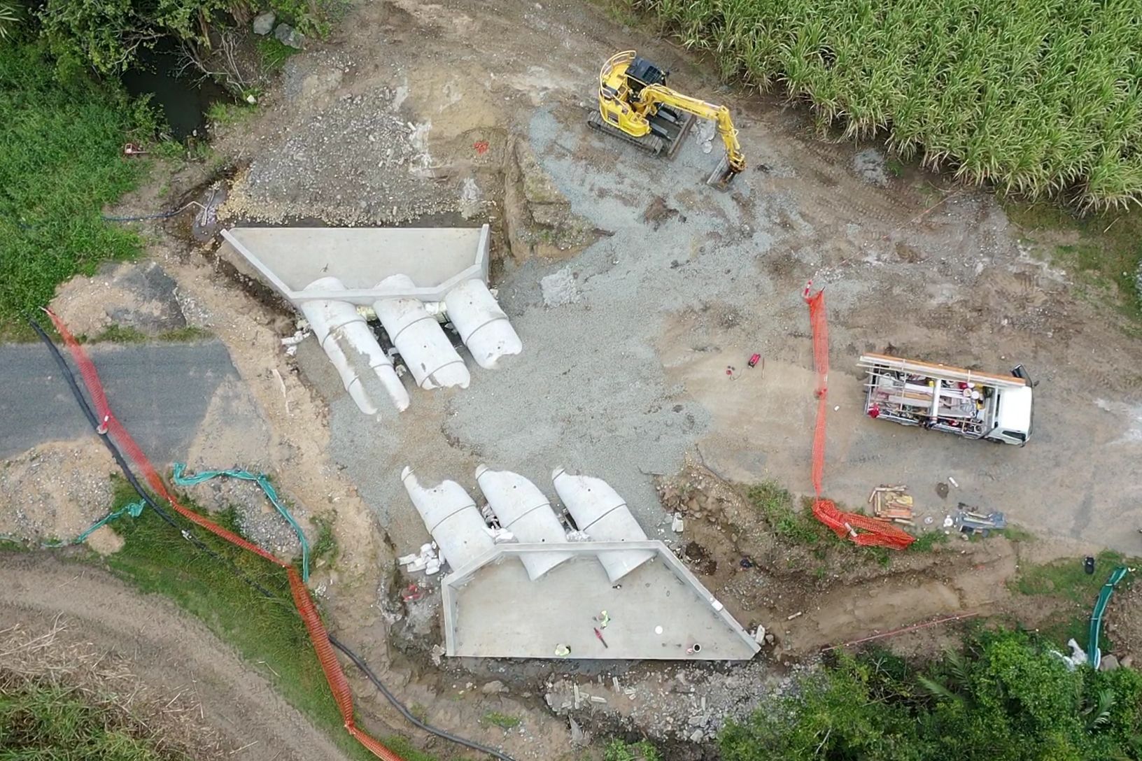 An Aerial View Of A Construction Site With A Yellow Excavator — Mass Construction Group Australia Pty Ltd in South Mackay, QLD