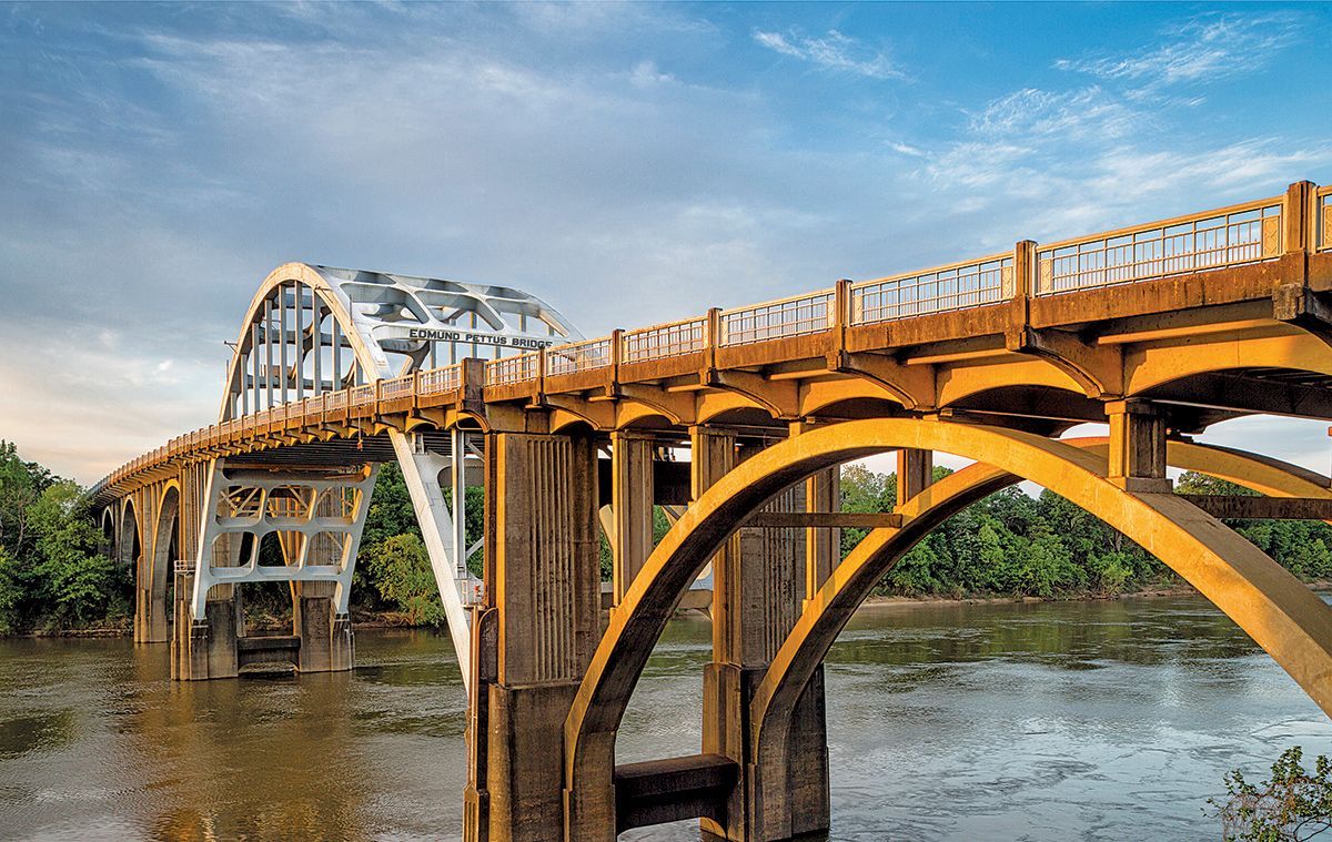 A bridge over a river with a blue sky in the background.