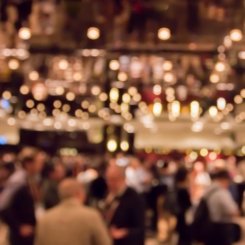 A blurry picture of a crowd of people at a party