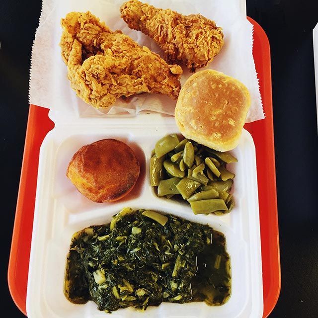 Fried chicken green beans and a biscuit on a styrofoam tray