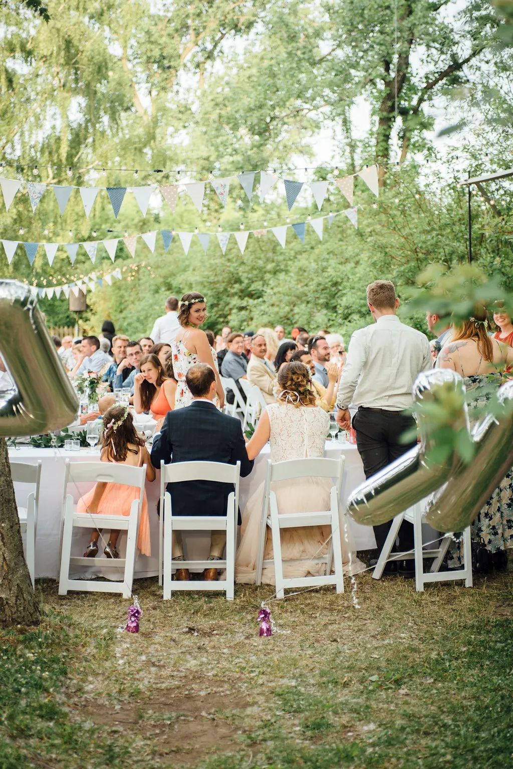A group of people are sitting at tables at a wedding reception.