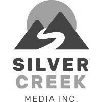 The logo for silver creek media inc. is a mountain with a river running through it.
