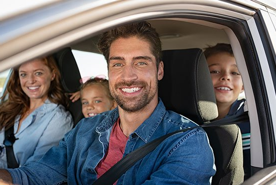 Happy Family Inside Car — Ogdensburg, NY — Truax Insurance Agency Inc.