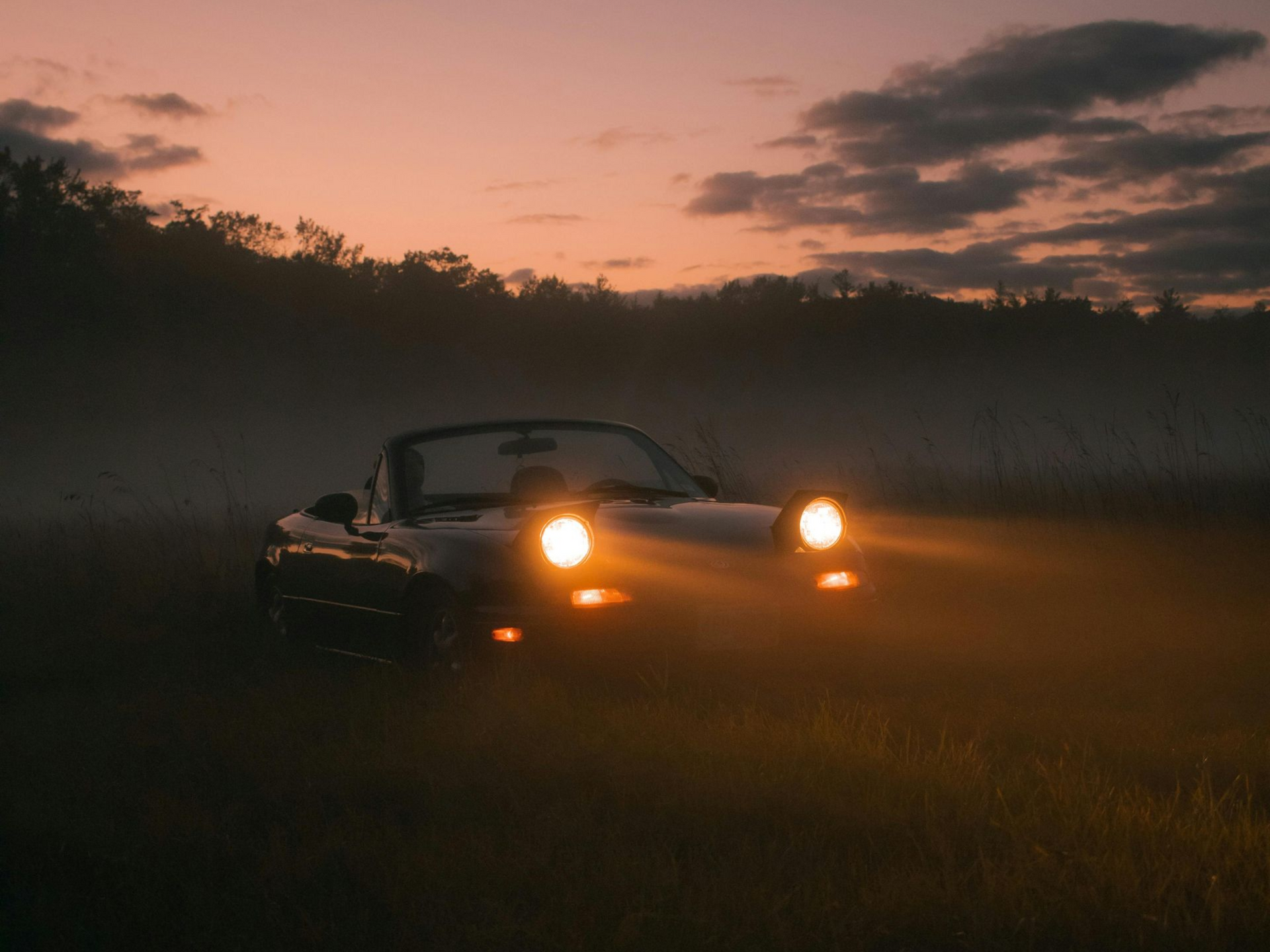 car with headlights on at night