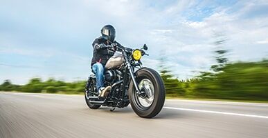 Man Driving Black Motorcycle — Bockman Batteries in Albury, NSW