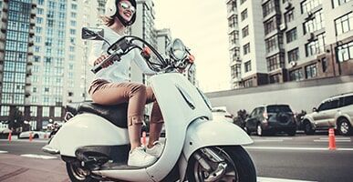 Beautiful Girl Driving A Scooter — Bockman Batteries in Albury, NSW