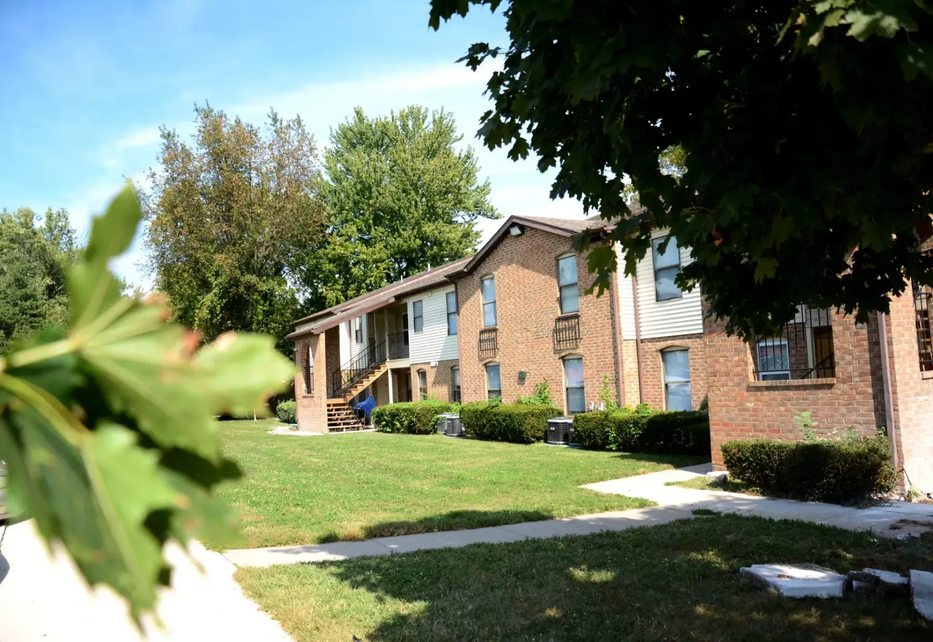 Photo of an apartment building with leaves framing the photo