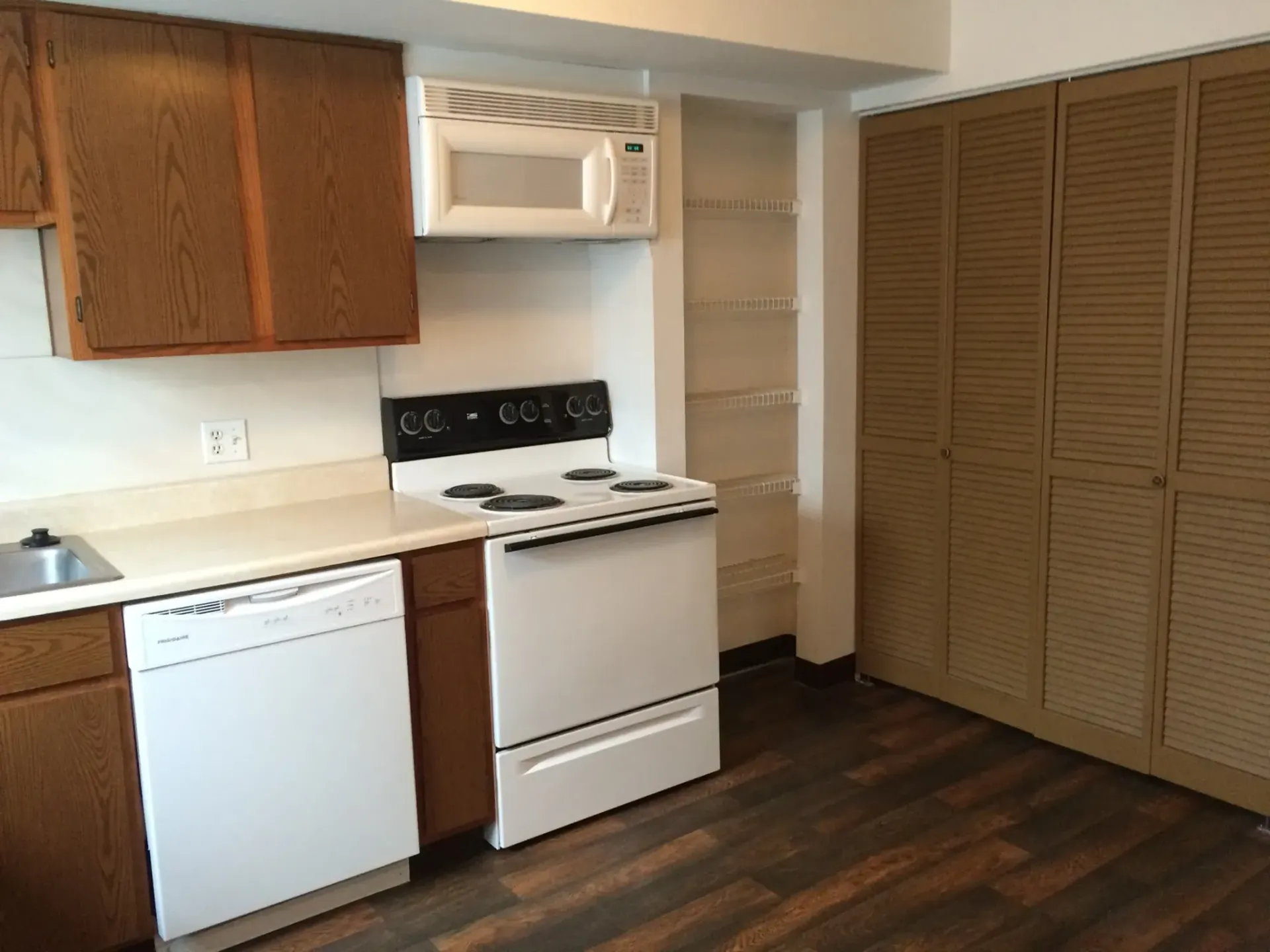 Photo of a kitchen, with a microwave above a stove