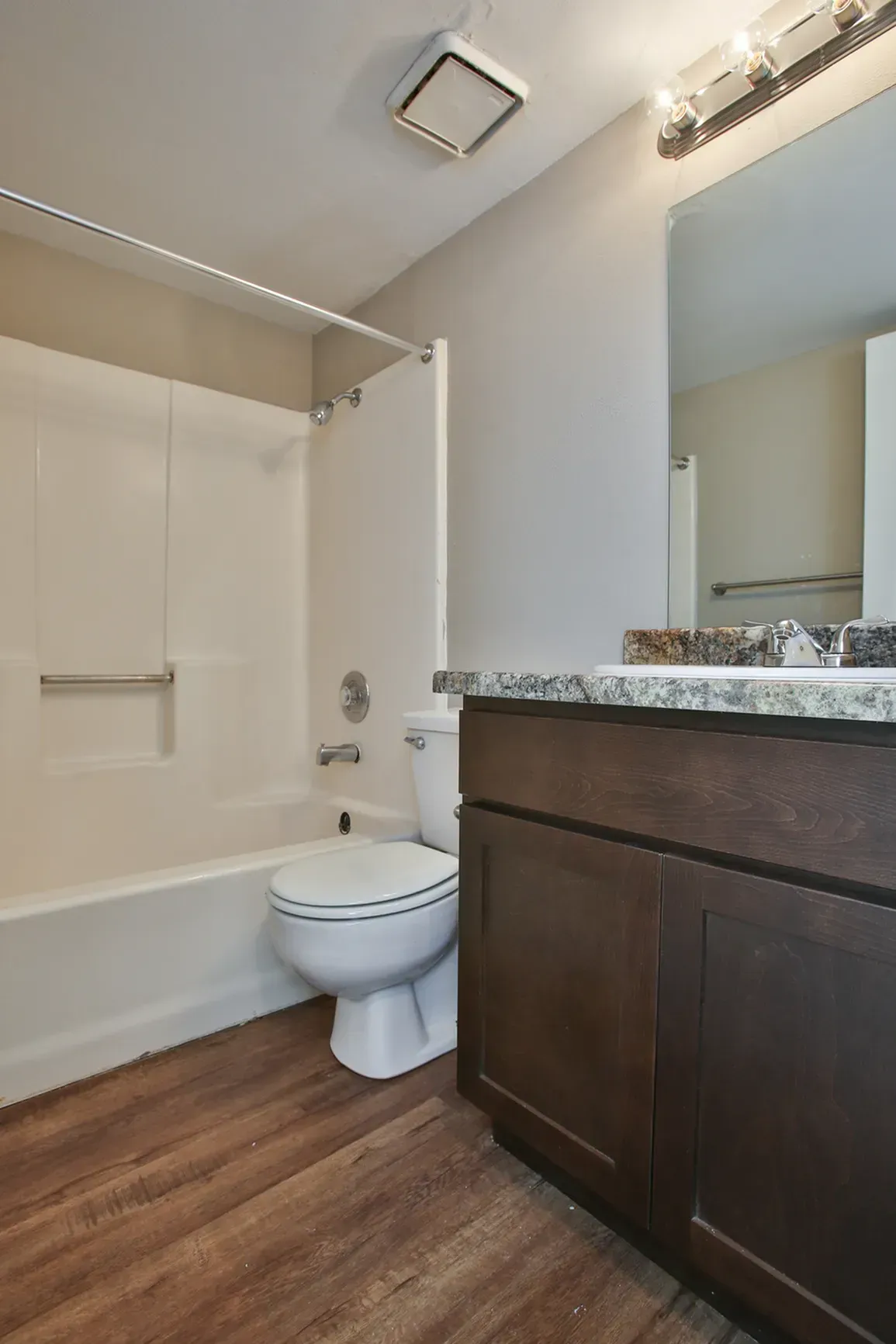 Photo of a bathroom with a shower and bathtub combo seen in the background