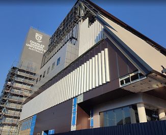 A Large Building With Scaffolding Around It Is Under Construction — Jakes Steel & Welding in East Arm, NT
