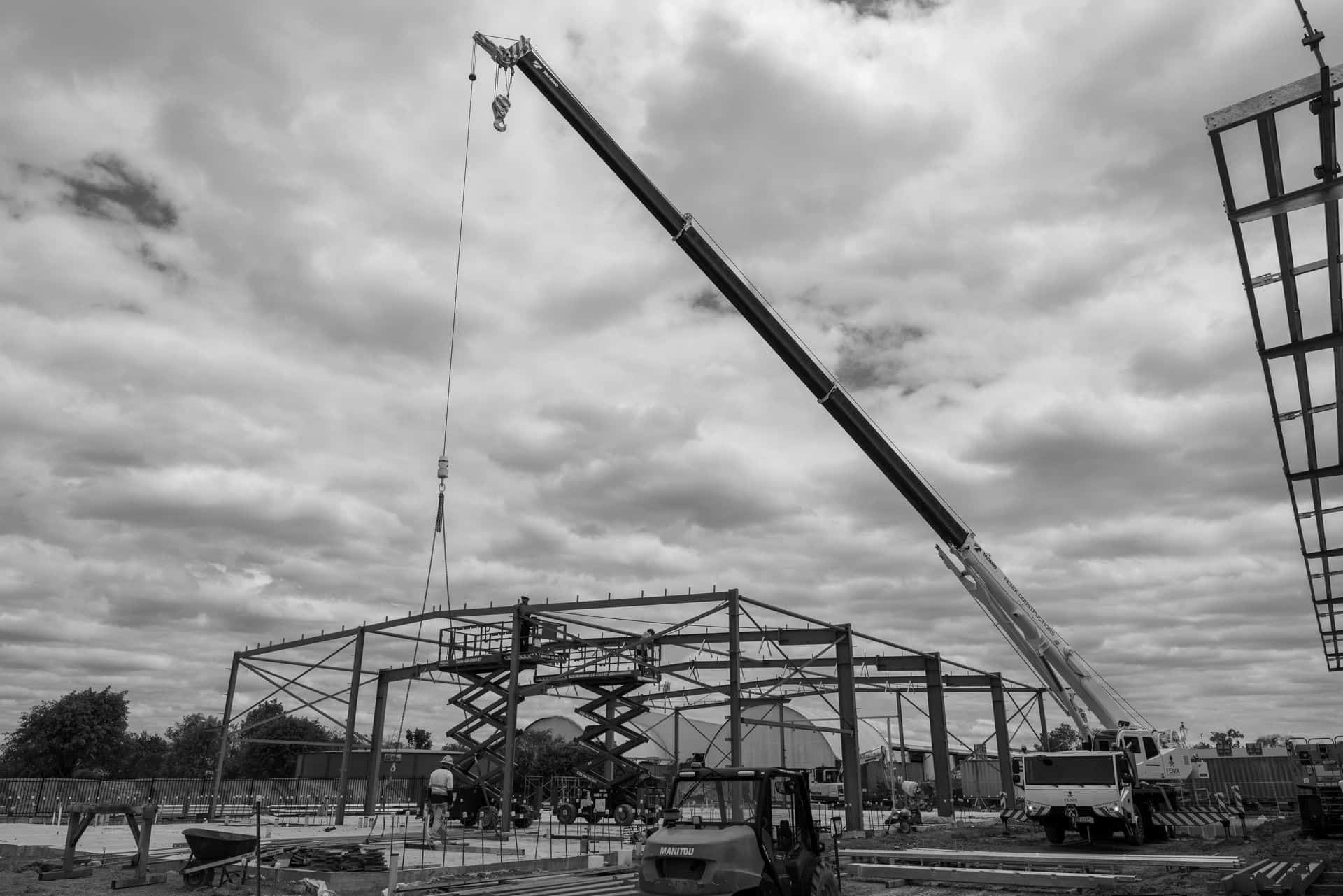A Black And White Photo Of A Construction Site With A Large Crane — Jakes Steel & Welding in East Arm, NT