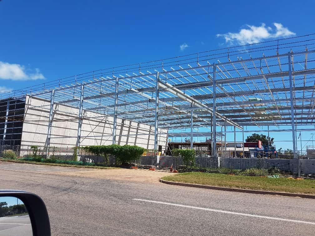 A Large Metal Structure Is Being Built Next To A Road — Jakes Steel & Welding in East Arm, NT