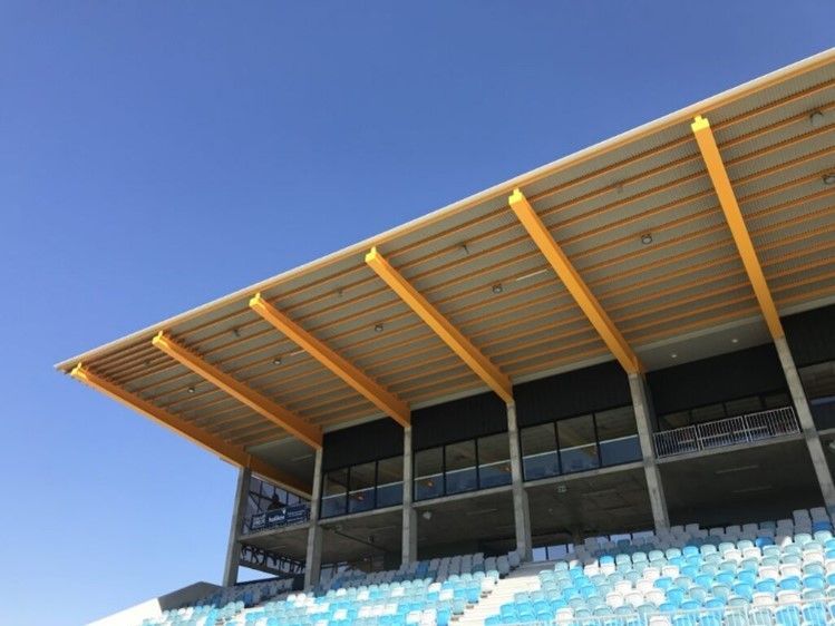 A Stadium With Blue And White Seats And A Wooden Roof — Jakes Steel & Welding in East Arm, NT