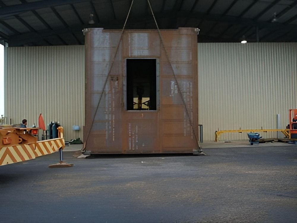 A Large Piece Of Metal Is Being Lifted By A Crane — Jakes Steel & Welding in East Arm, NT