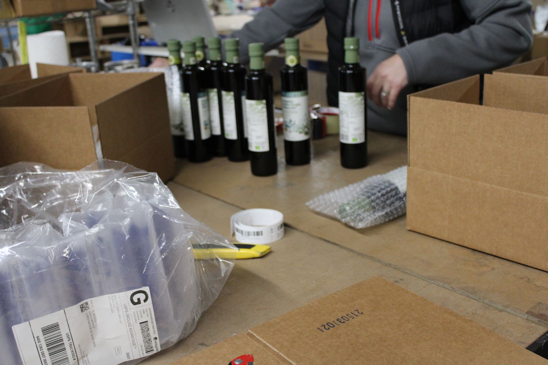 A child is sitting on the floor of a warehouse.