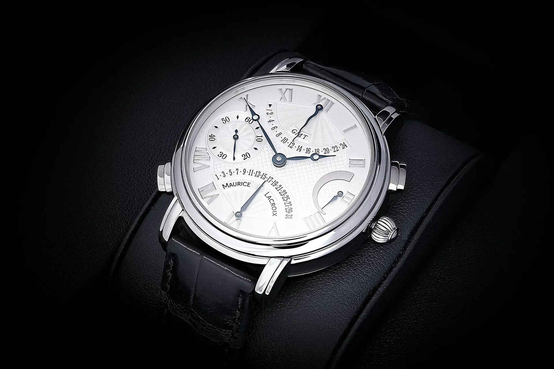 Silver wristwatch on a black leather cuff, showcasing multiple dials on a white face.