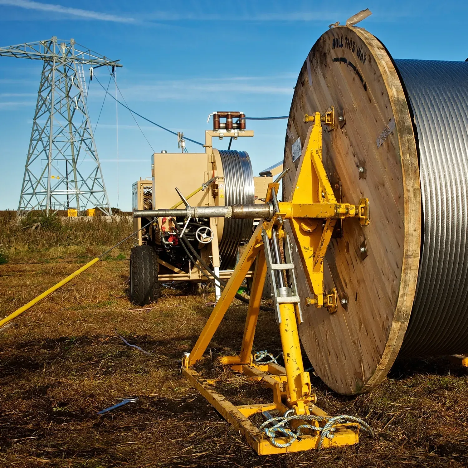 Man in suit and glasses smiles, hand on chin. Black and white portrait.