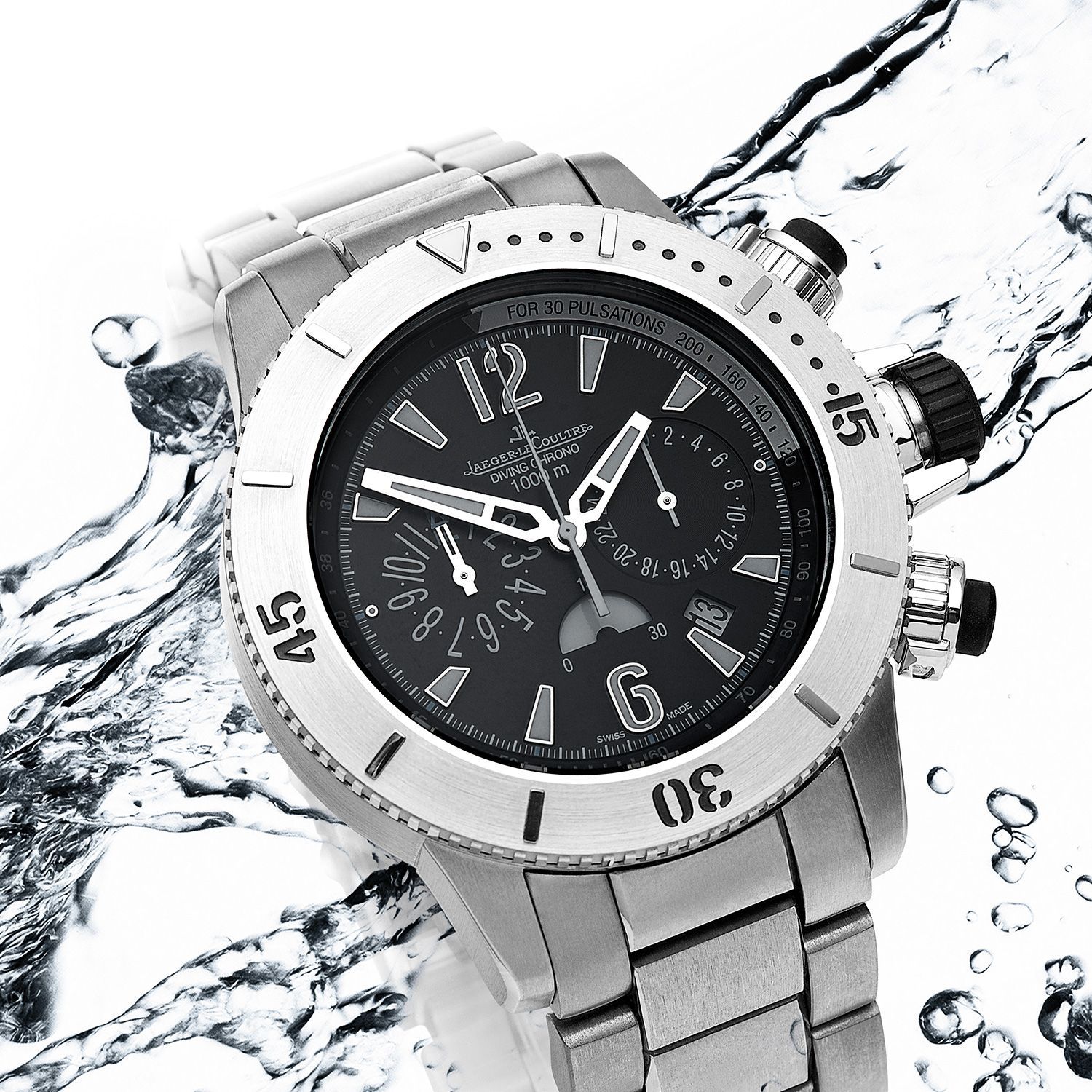Silver wristwatch with a black face, in water.