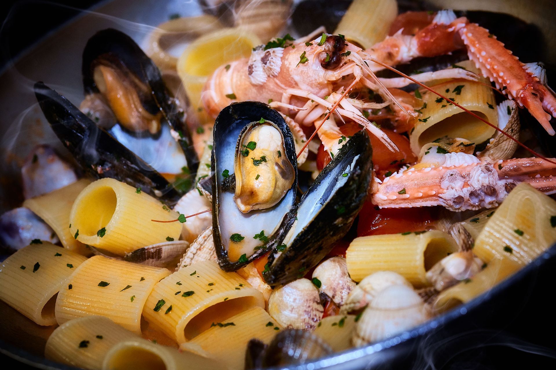 Pasta dish with mussels, shrimp, and clams.