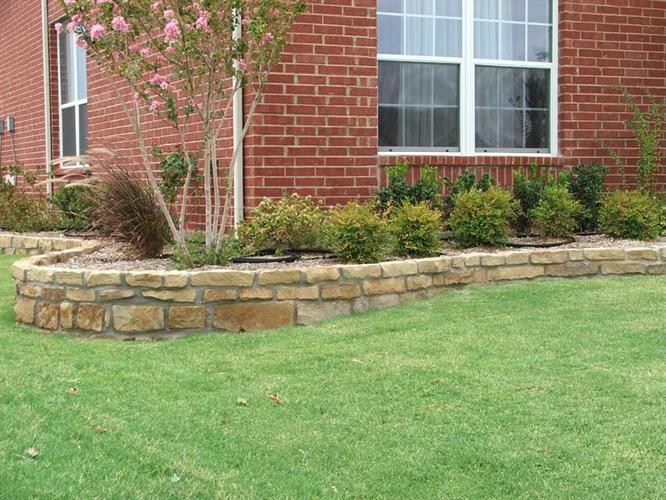 Green lawn with stone wall