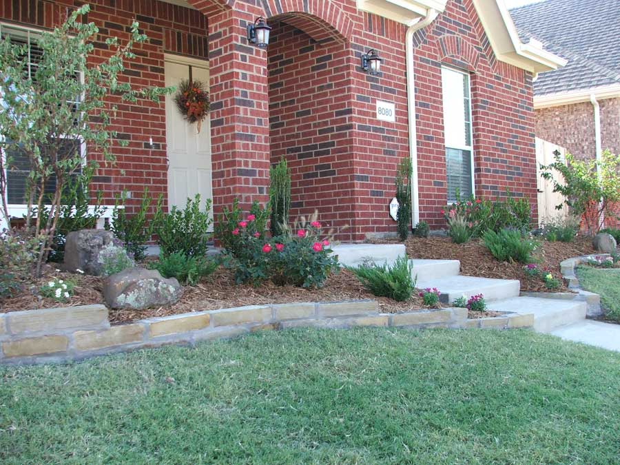 Green lawn and a garden outside of the front door