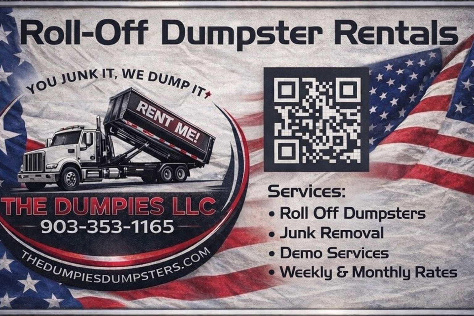 Two black dumpsters are parked in a dirt lot in front of a pile of trash.