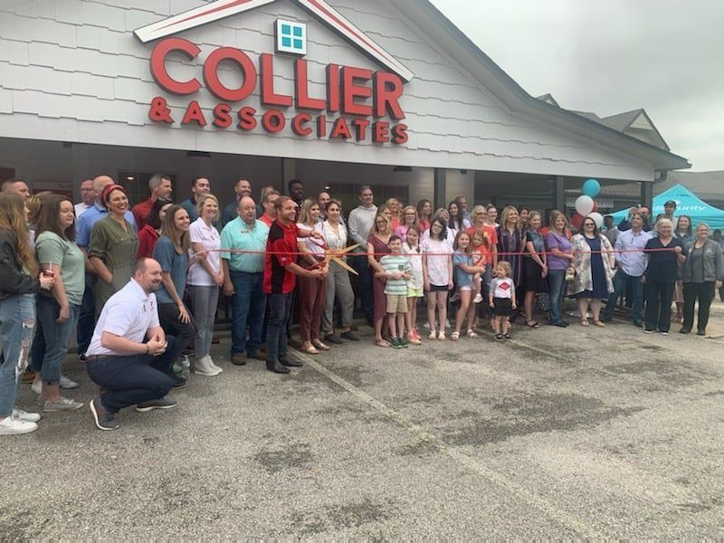 People gather for a ribbon-cutting ceremony in front of