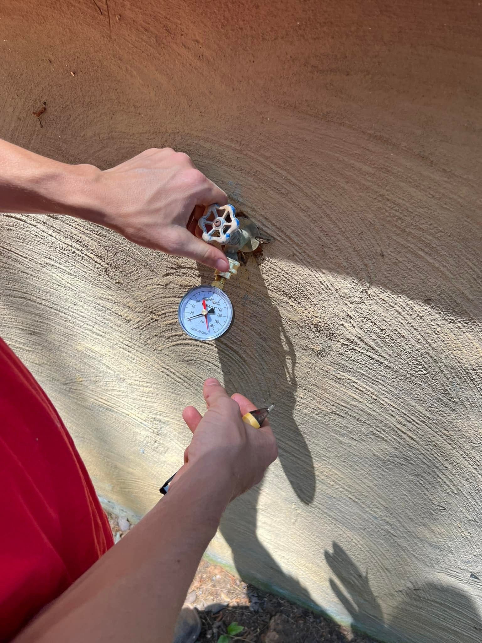 A person is holding a compass and a thermometer in their hands.