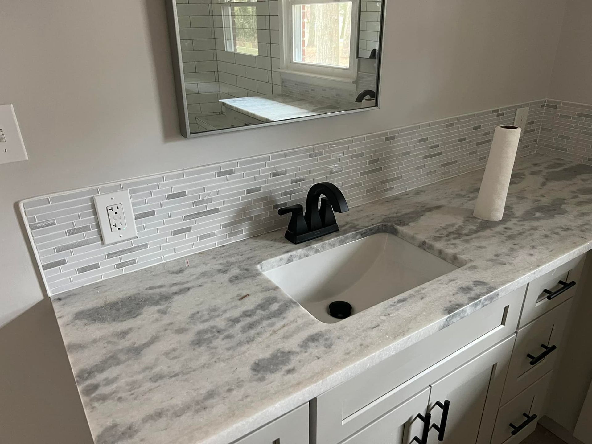 A bathroom vanity with a sink and a mirror.