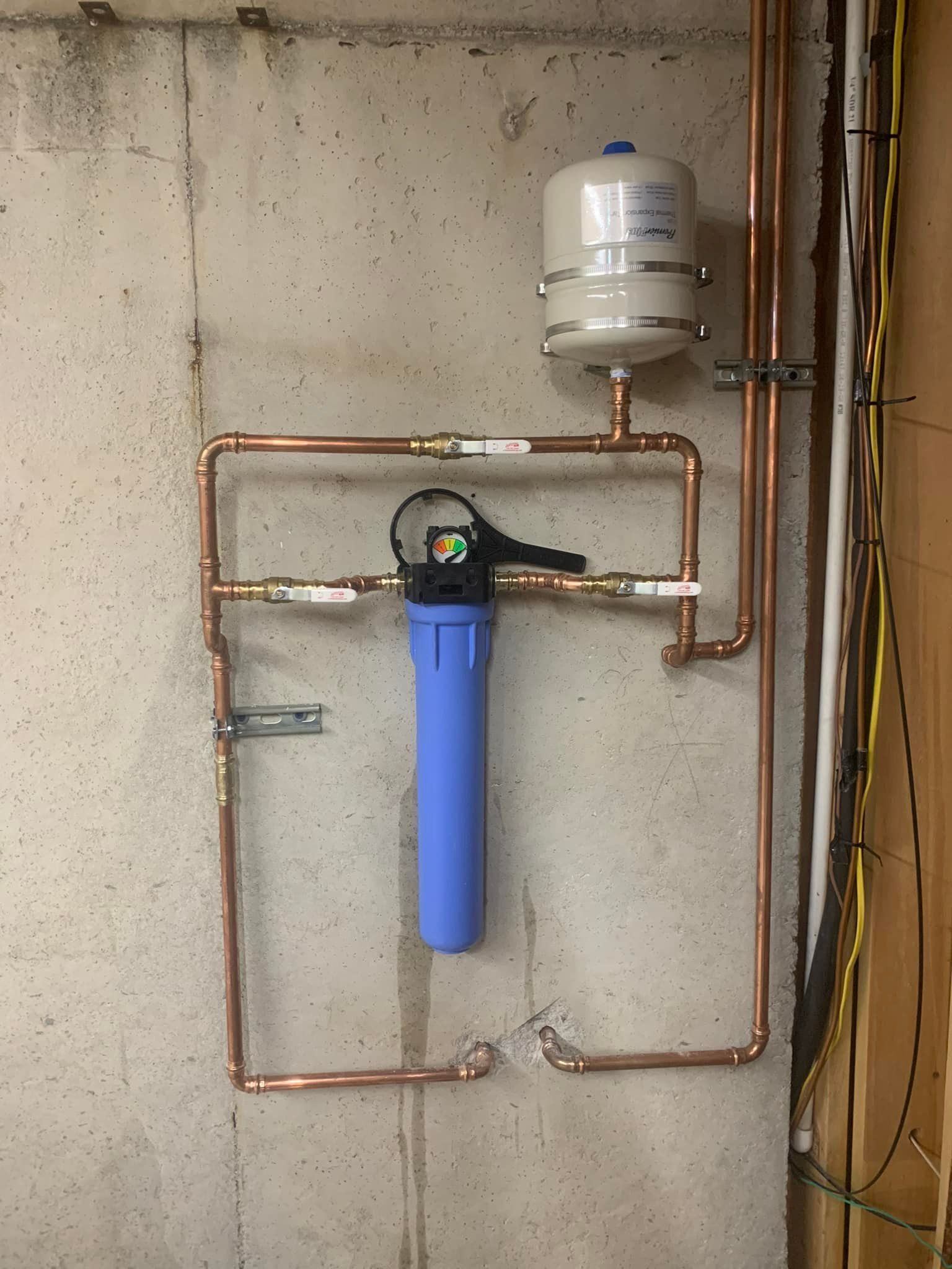 A copper pipe with a blue filter attached to it