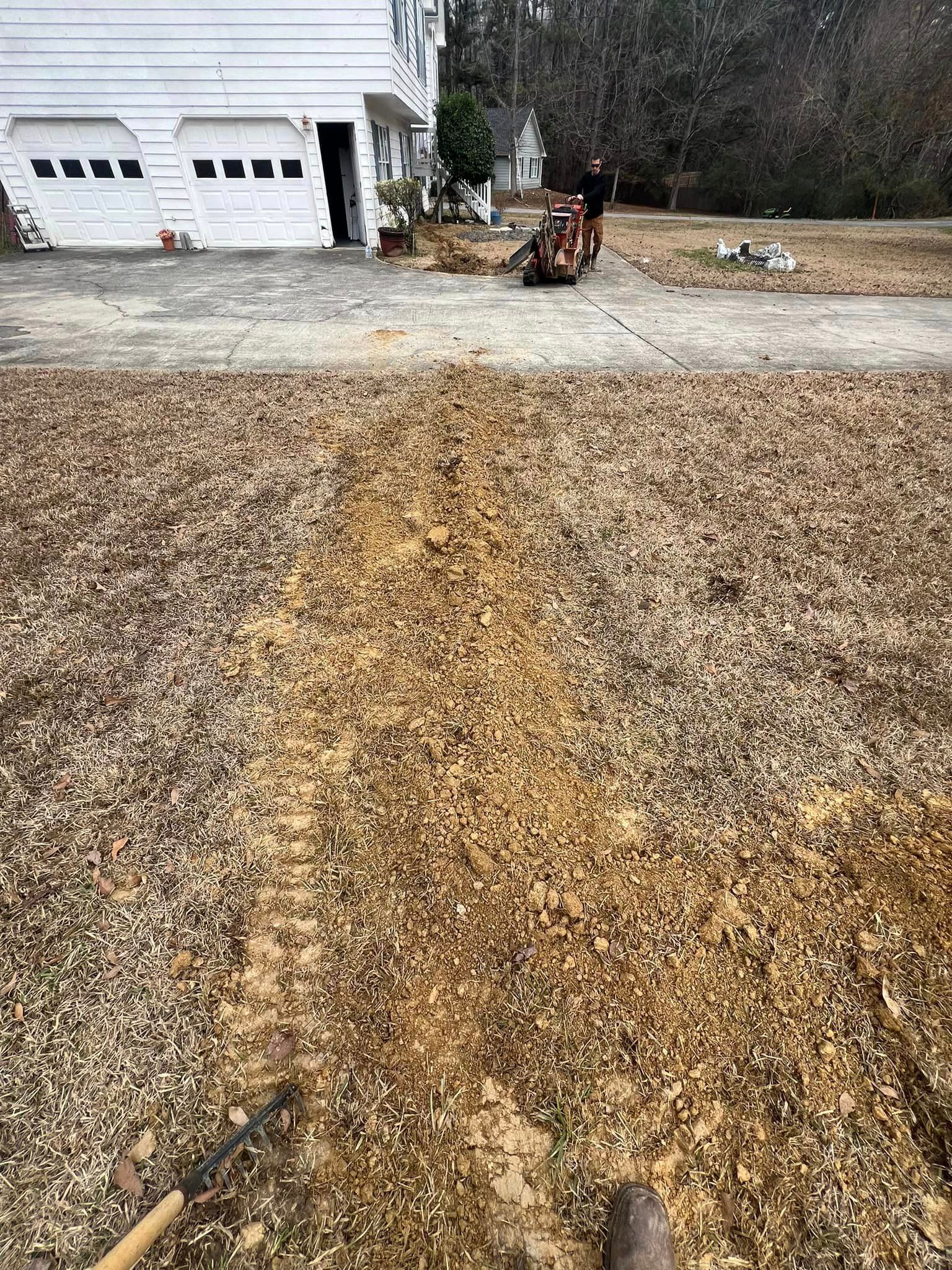A large pile of dirt is sitting in front of a house.