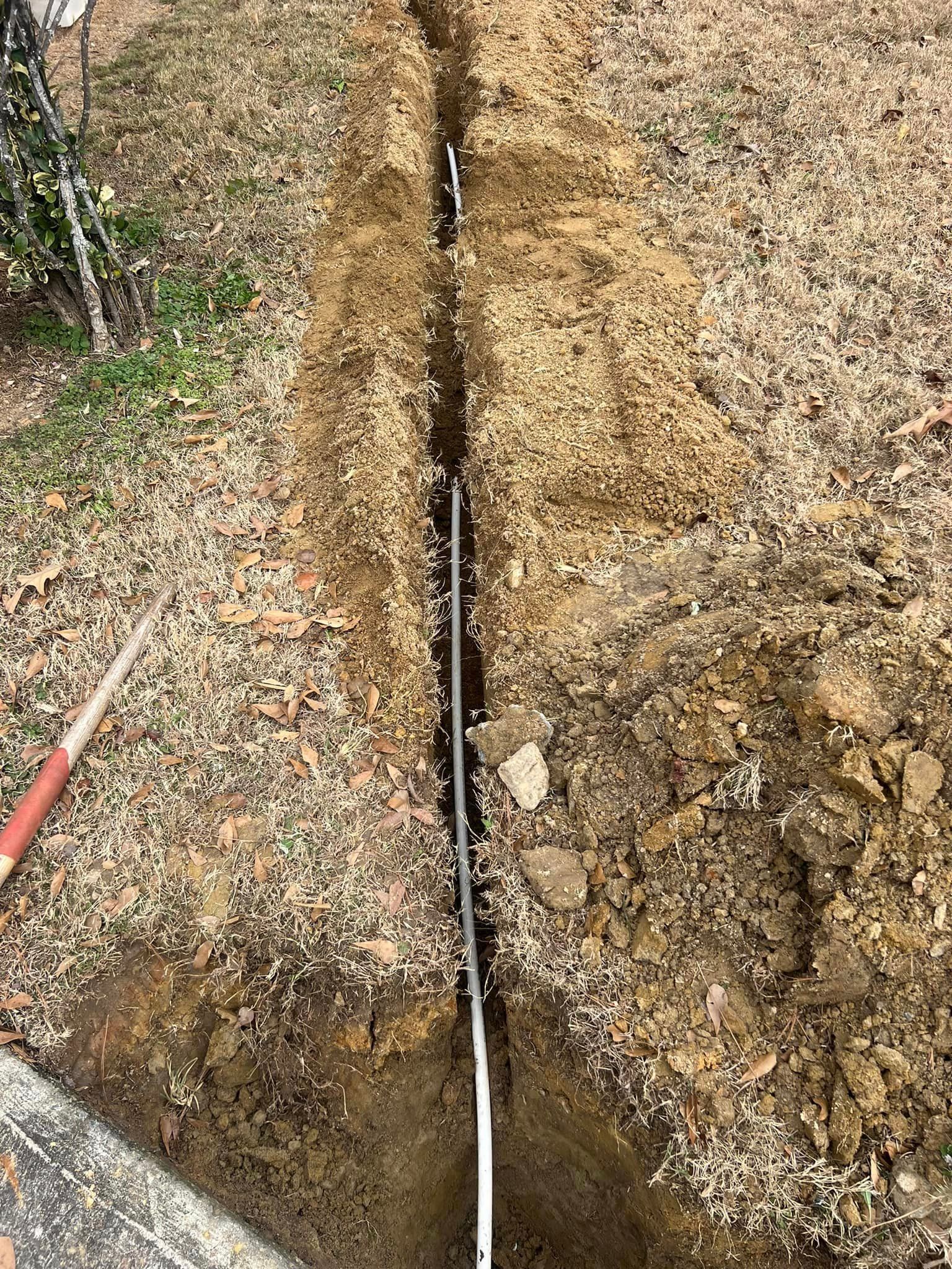 A person is digging a hole in the ground with a shovel.