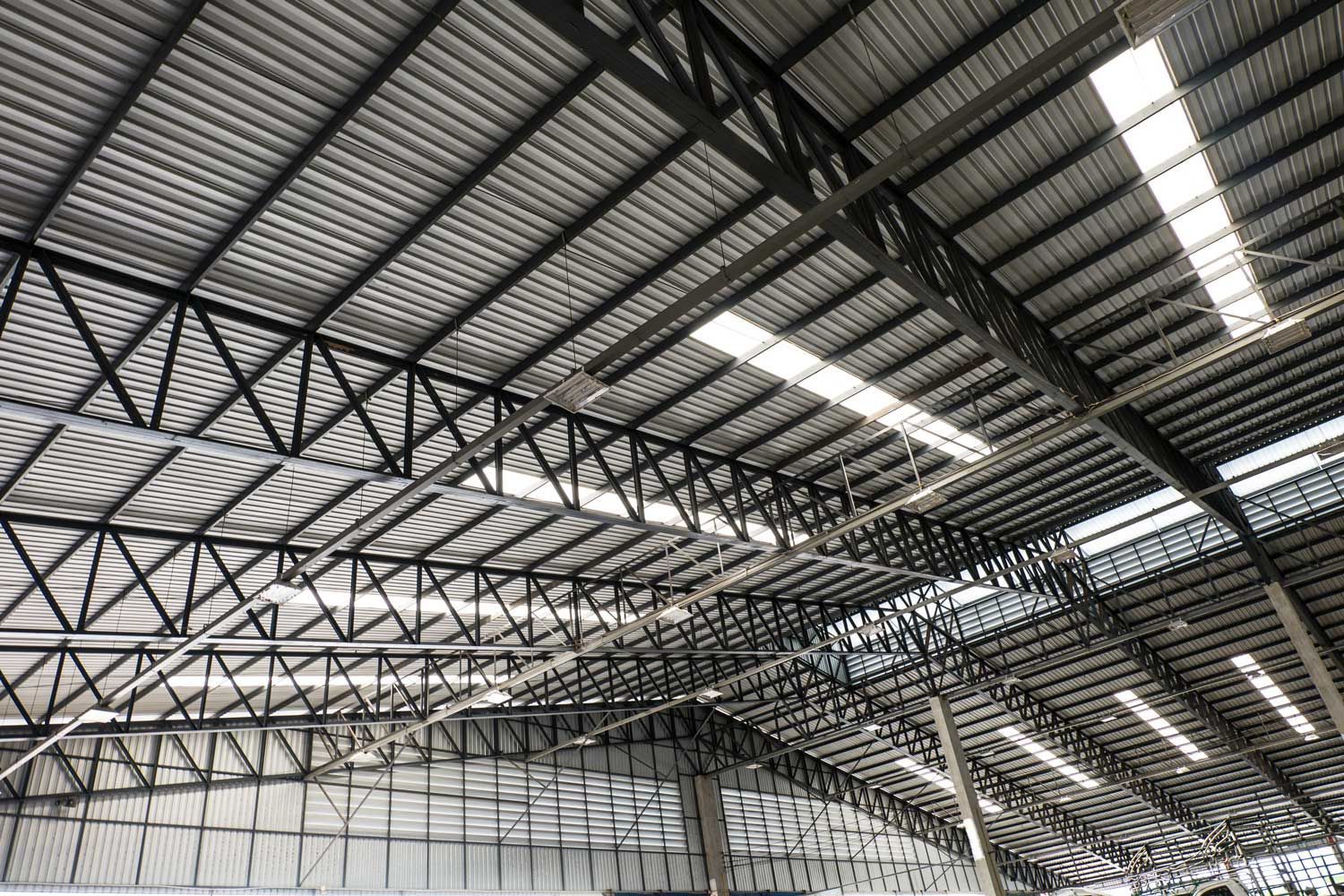 Steel roof structure with corrugated metal panels and skylights.