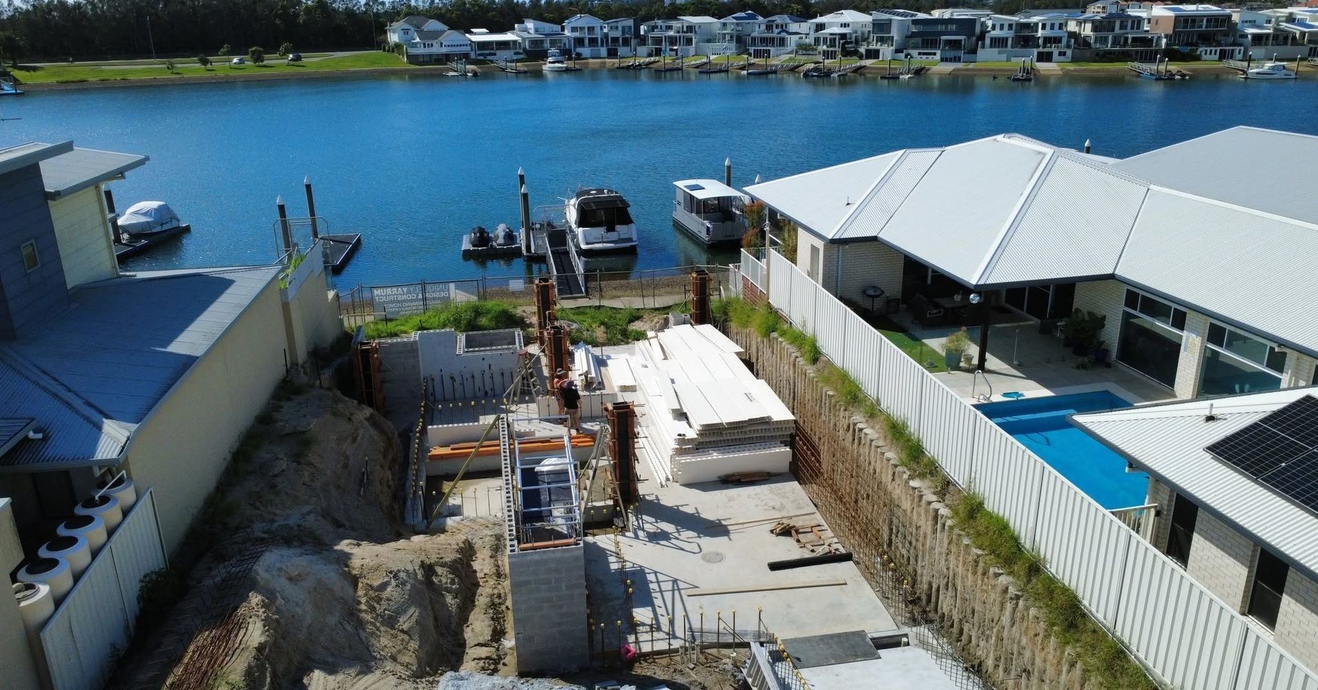 Boat shed footings under excavation at a canal-front build in Port Macquarie.