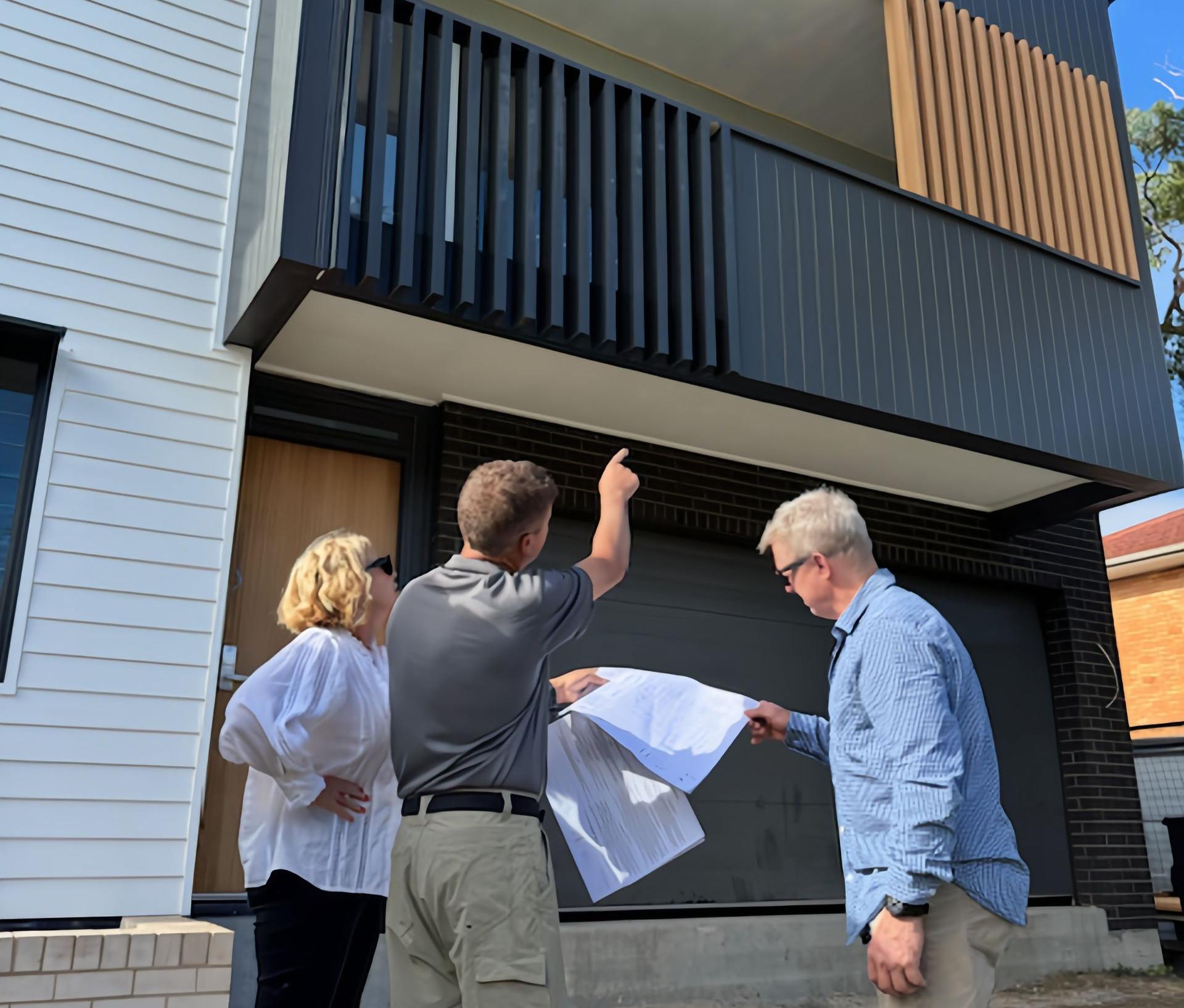 Architect and homeowners reviewing house plans during construction in Port Macquarie