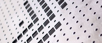 A close-up of a piece of metal with holes in it.