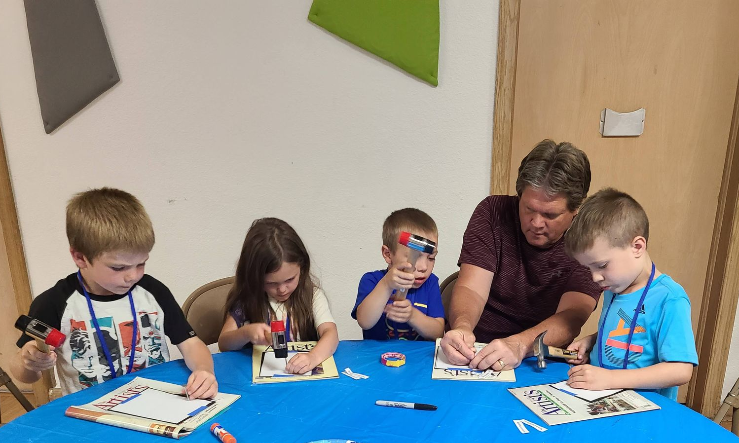 A group of children are sitting around a table.