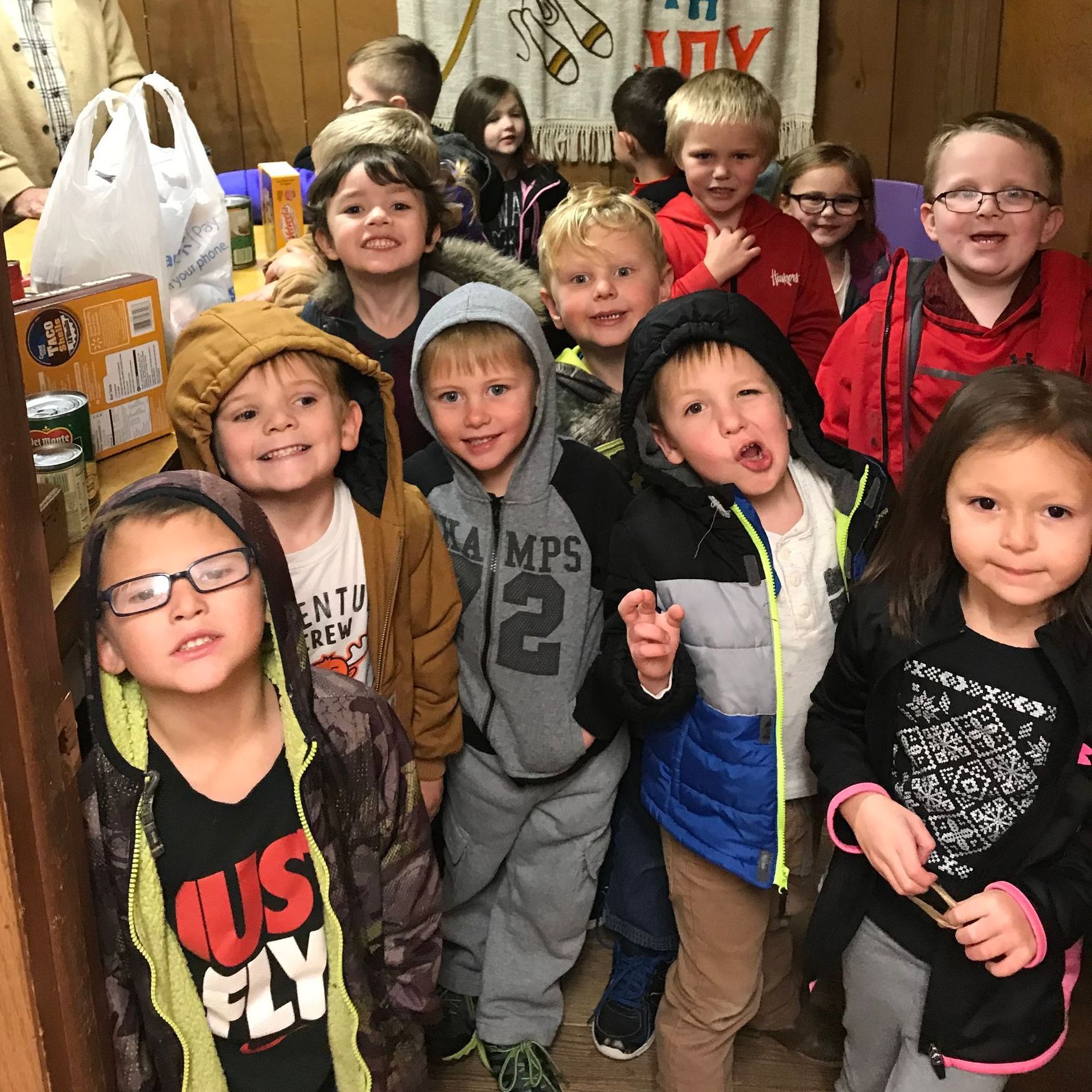 A group of children are posing for a picture in a room.