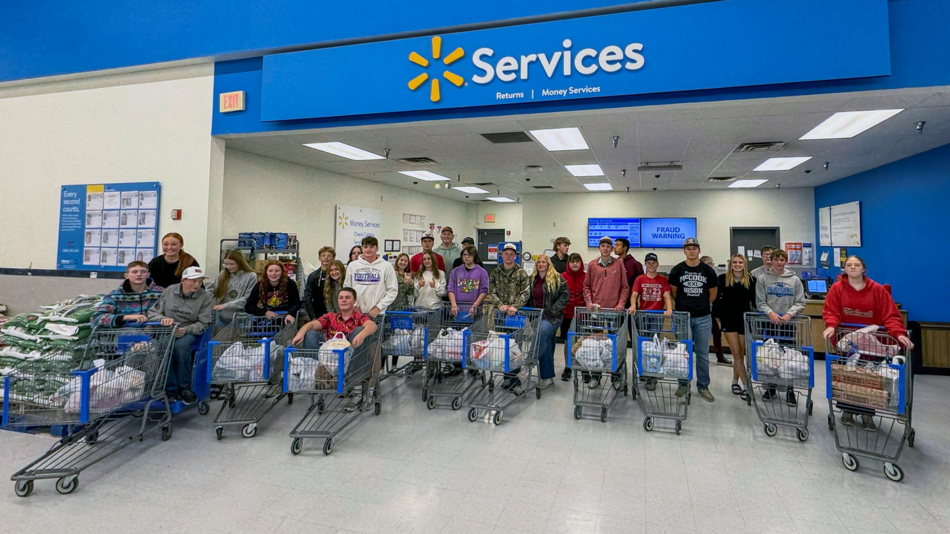 A group of people are standing in front of shopping for soldiers.