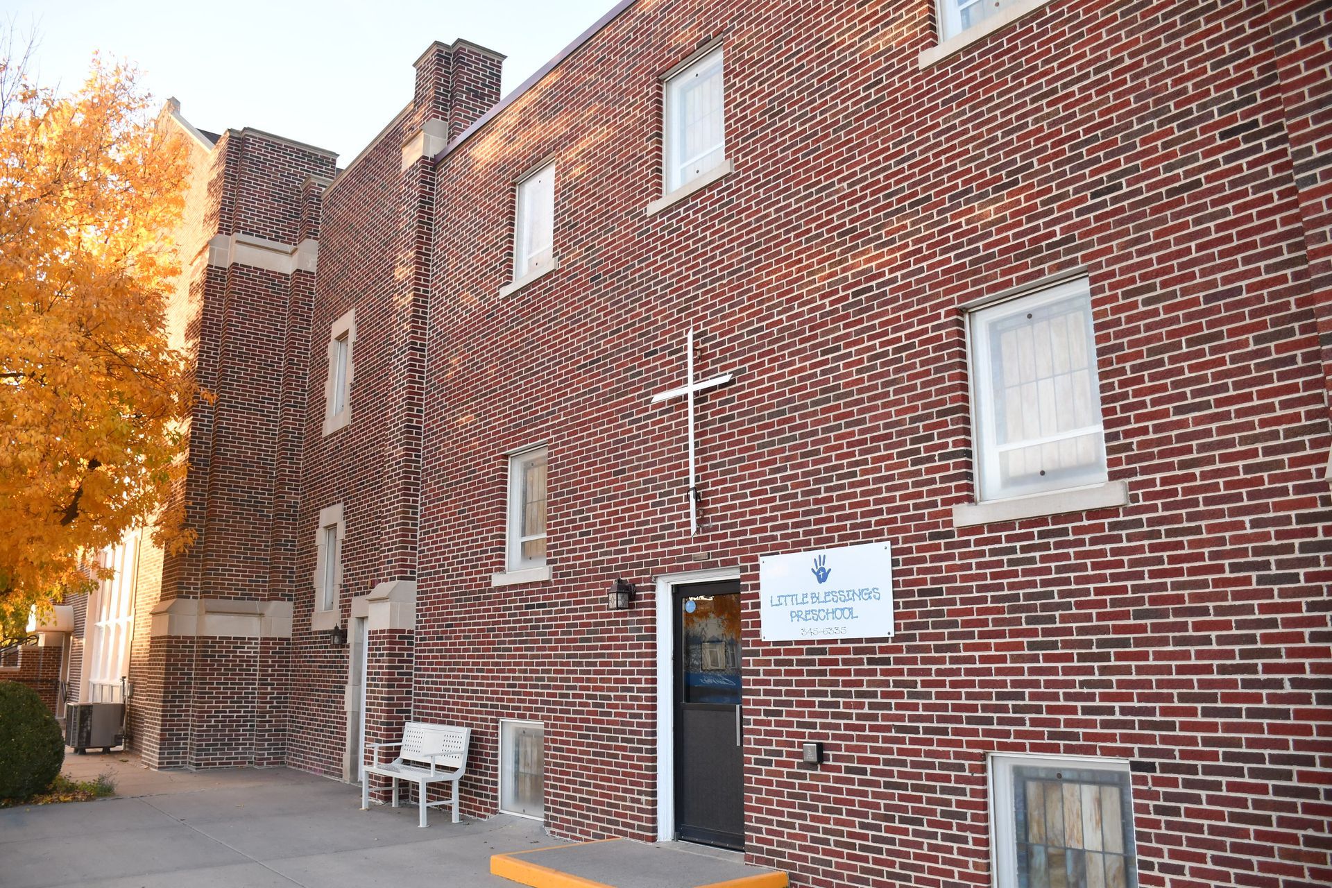 A brick building with a cross on the side of it