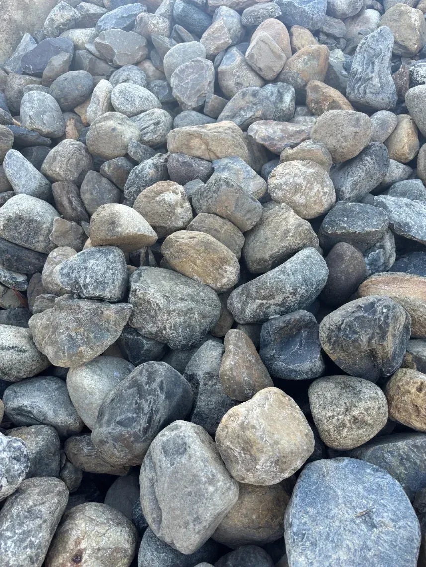 Close-up of gray and beige rounded stones piled together.