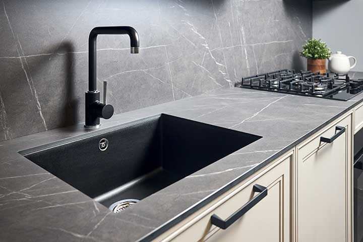 Kitchen sink area with black square matte sink tap in contemporary style. 