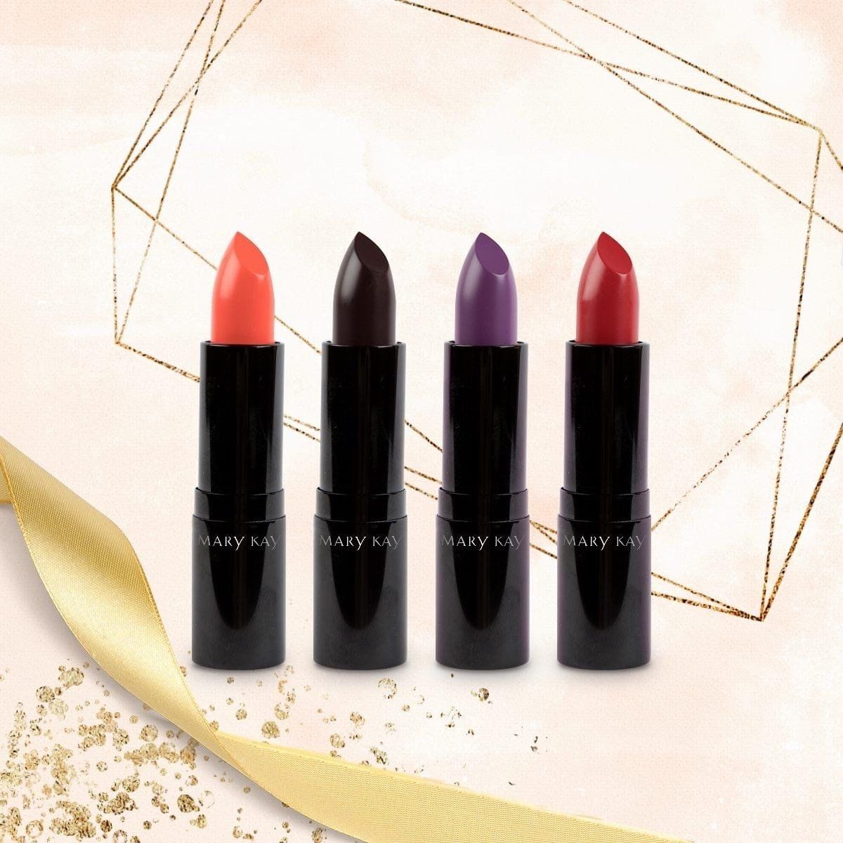 Four lipsticks in bright colors, arranged on a light background with a gold ribbon and geometric shapes.