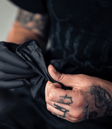 Tattoo Artist Wearing Gloves — South Bend, IN — Electric Rose Inc