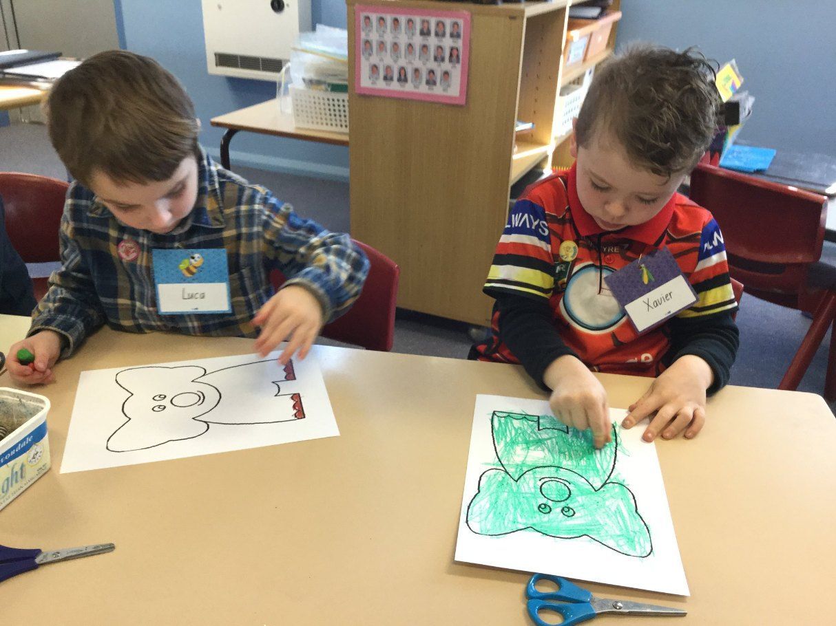 Two Young Boys Are Sitting at a Table Making Crafts — Earth Angels Child Care Centre in Tinonee, NSW