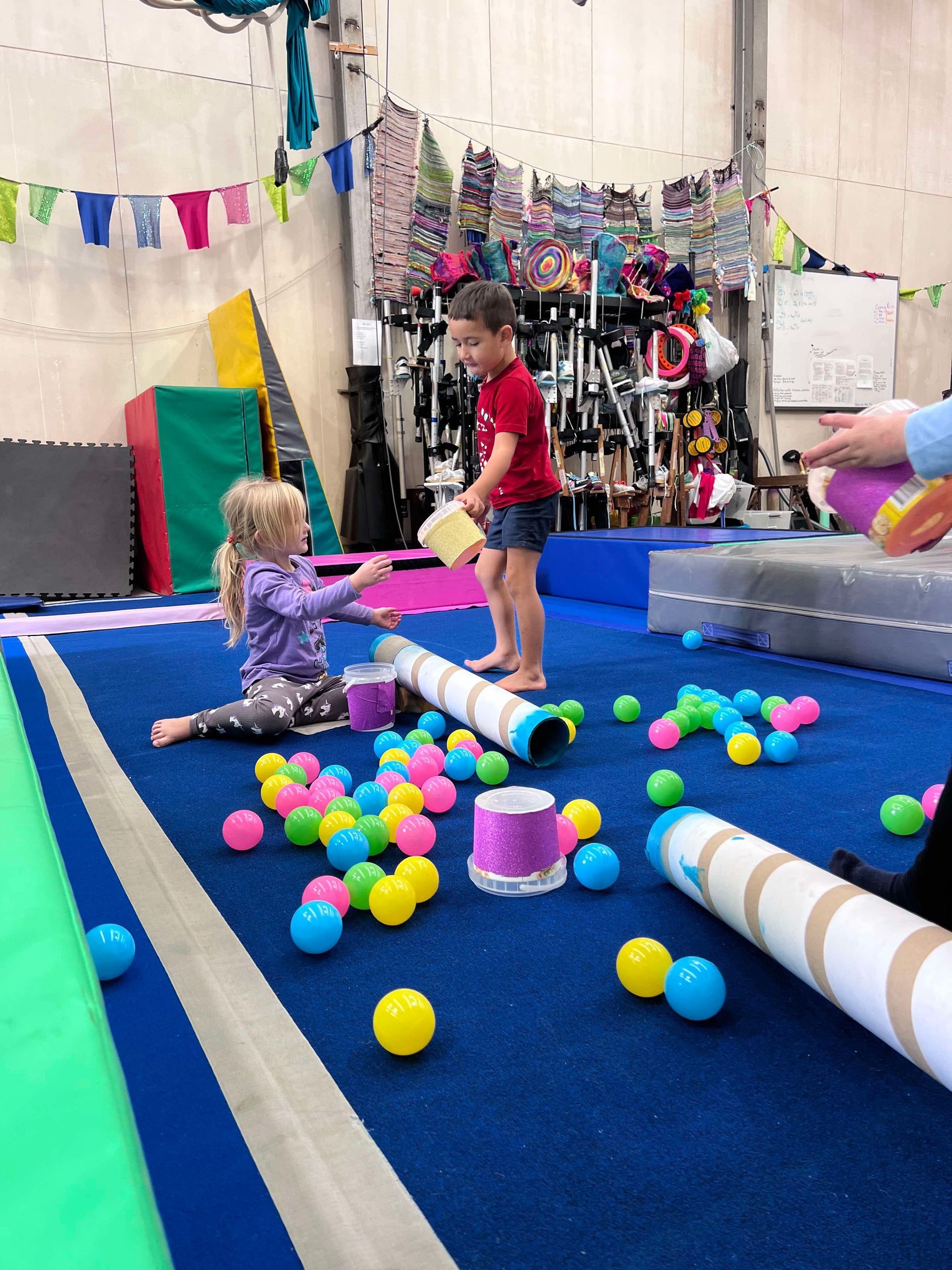 Children playing with balls and tubes in a gym — Earth Angels Child Care Centre in Tinonee, NSW